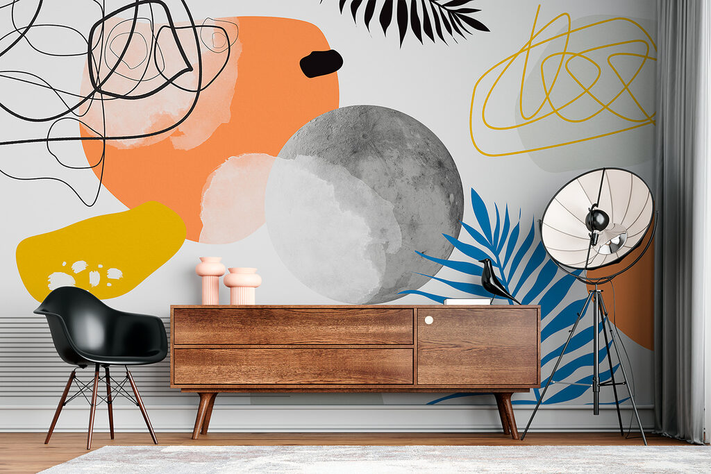 Een kleurrijk kunstwerk met zwart-witte cirkels en bladeren in een interieur